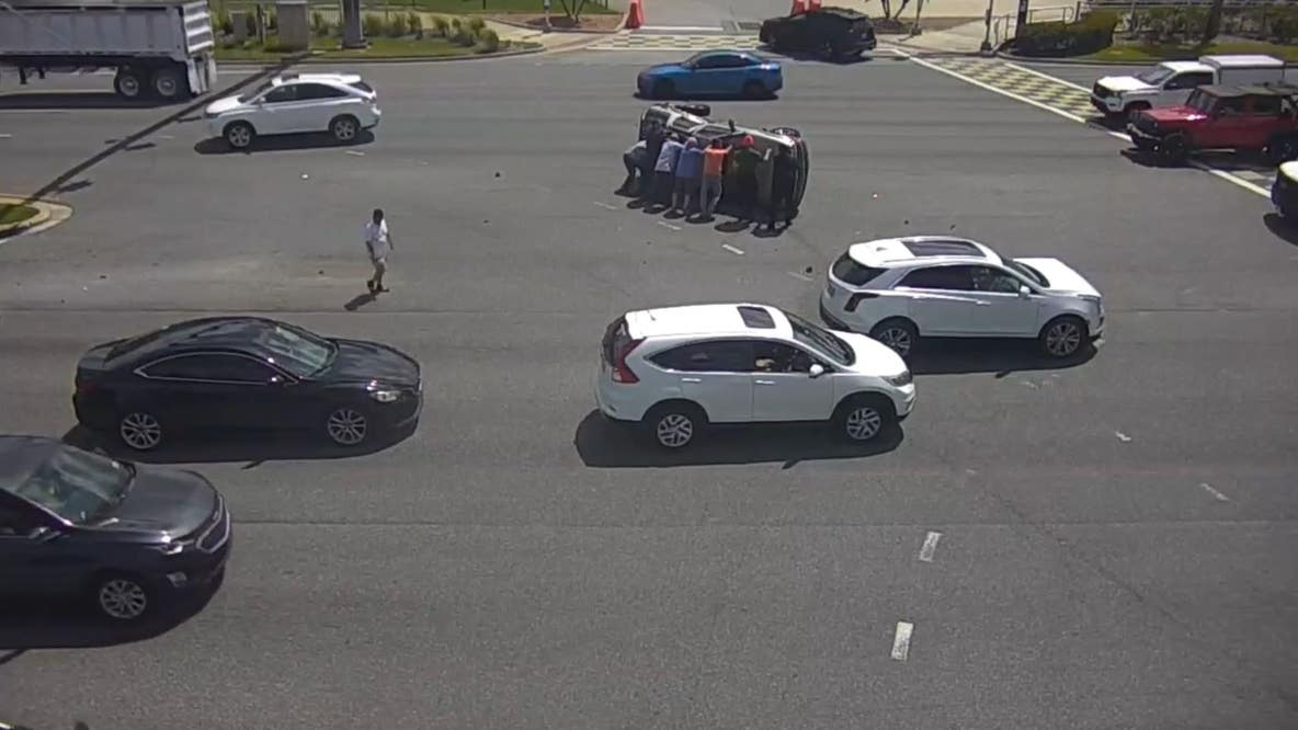 Good Samaritans help overturn SUV flipped in crash